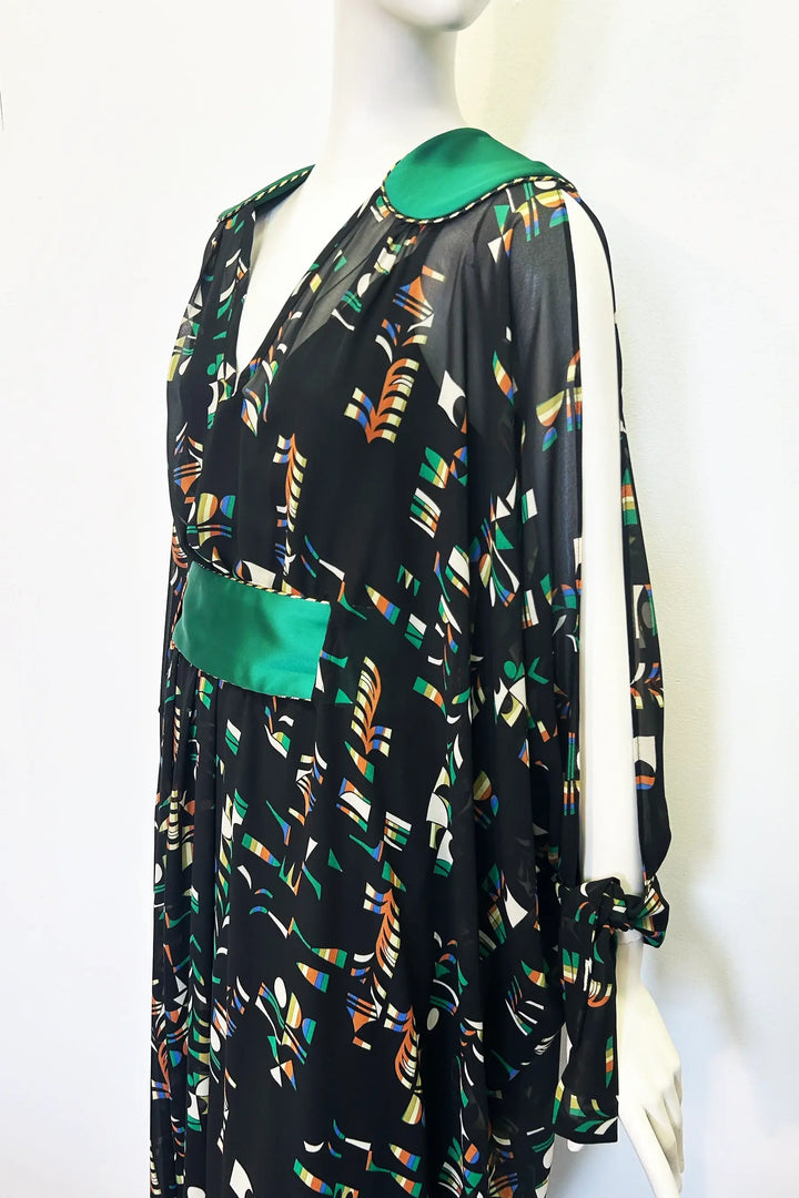 Mannequin wearing a black kaftan with colourful pattern and green accents on a white background. Handmade by Holly Campbell Studio in Edinburgh.